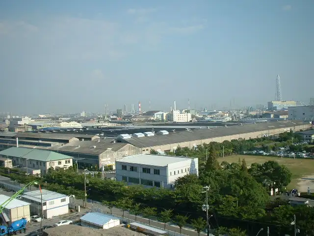尼崎臨海エリアの遠景。工場内の木々や通りの街路樹から緑の潤いを感じられます。