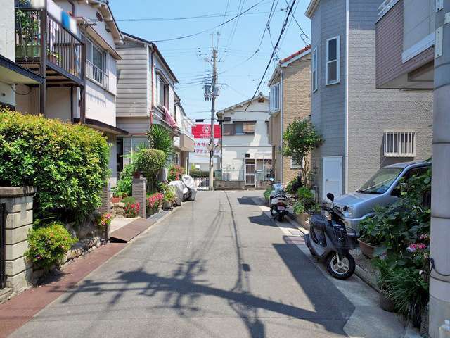 町の南東部を西方向から見た景色。道幅の狭い街路沿いに一戸建てが並んでいます。
