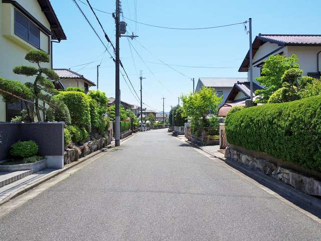 町の西部を北東方向から見た景色。道幅が広く緑が多い良好な住環境です。