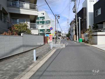 敷地東側の前面道路。マンションや一戸建てが立ち並んでいます。