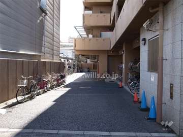 駐車場入口。建物1階部分に駐輪場が設置されています。