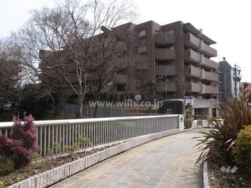 サニーヒルズ池田五月山の外観（北西側から）　手前は五月山体育館に続く橋です。