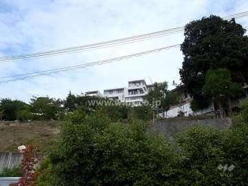 万松園の遠景。周辺はマンションと一戸建てなどが混在する静かな住宅地です。