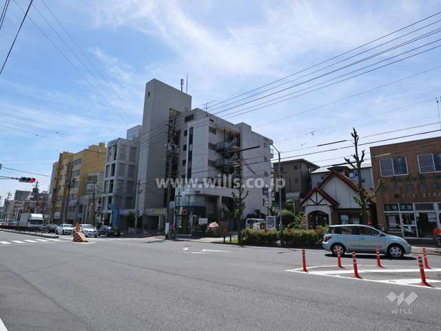 メゾン・ド・星ヶ丘セーヌの遠景(北西側から撮影)周辺はマンションと商業ビル等が混在するエリアです。前面道路は片側二車線のバス通りです。