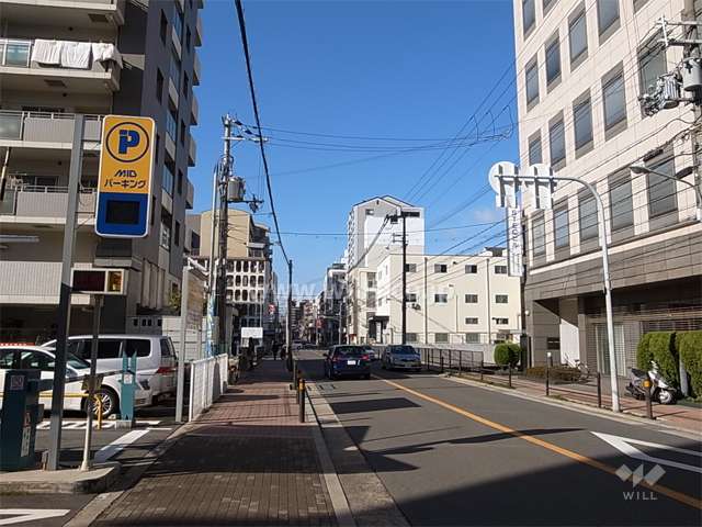 敷地北側の前面道路。周辺は住宅の他、事務所や店舗も立ち並んでいます。