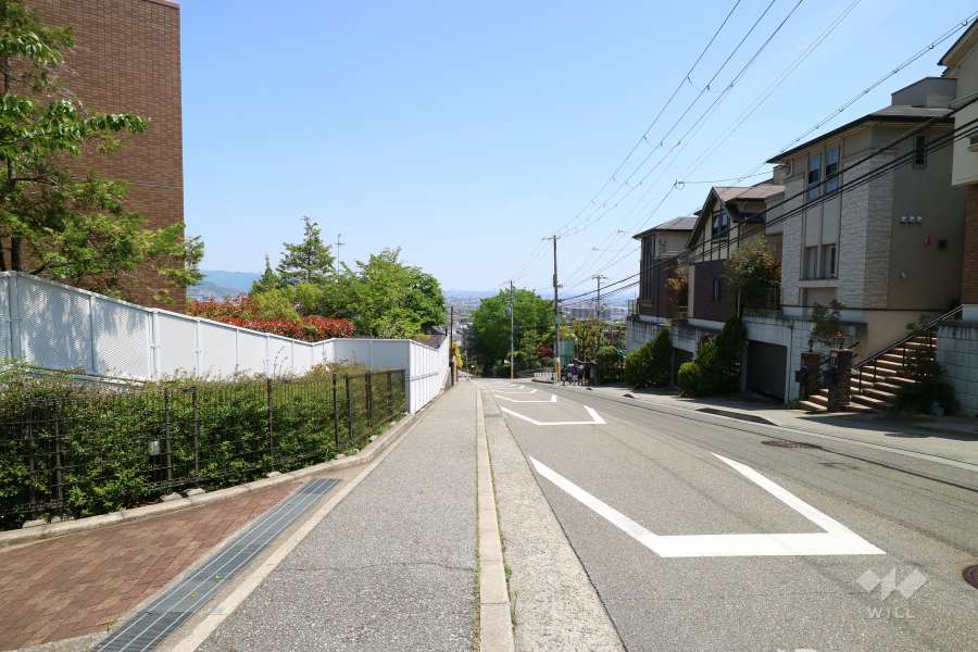 敷地南側の前面道路。周辺は高台の一戸建てが中心に立ち並ぶ住宅地です。